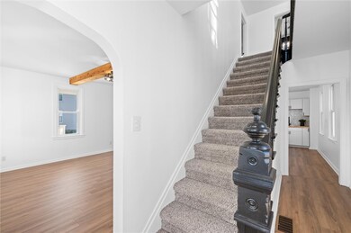 Entry leading to living room, kitchen, and to 2nd