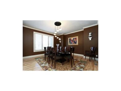 Dining room with plantation shutters and maple har