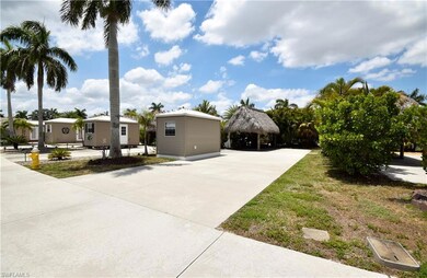 View of front facade featuring a detached carport, concrete driveway, and a gazebo