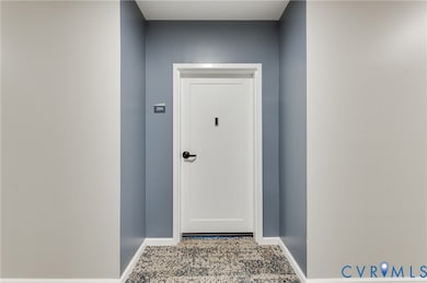 Doorway featuring baseboards