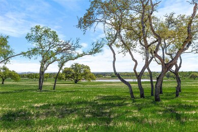 View of grassy yard with a water view
