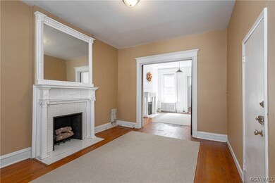 Hardwood floored living room with radiator and a f