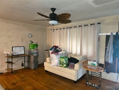 Living room with ceiling fan and hardwood / wood-s