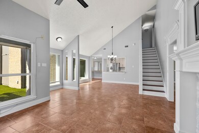 This spacious floorplan is showcasing the staircase, dining area, and living room—highlighting the home’s open layout, natural light, and smooth flow between main living spaces.
