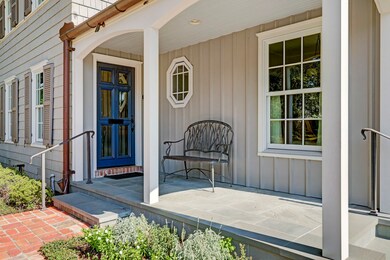 Charming covered front porch with custom lacquered front door.  Updates include: steel handrails from Julius Blum, copper gutters, double paned windows, siding and walls.