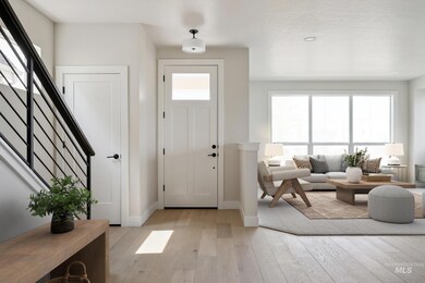 Foyer entrance featuring stairs and light wood-type flooring