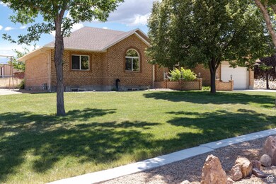 Single story home featuring a front lawn, brick siding, and a garage