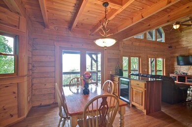 Dining area featuring wine cooler, french doors, a wood ceiling with exposed beams, wooden walls, and hardwood / wood-style floors