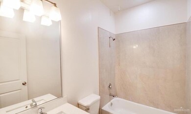 Full bathroom featuring tiled shower / bath, vanity, and toilet