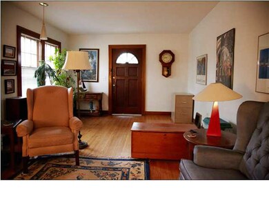 Living room photo facing East. Front door is in ce