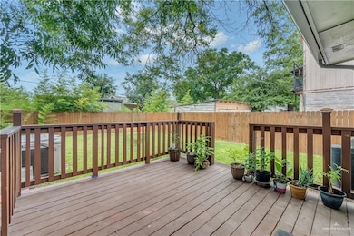 Wooden terrace with a lawn and central AC unit