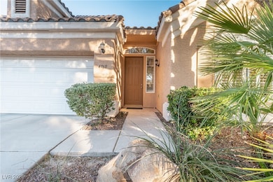 Doorway to property featuring an attached garage,