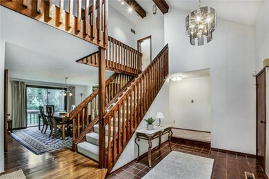 Two-story entry features beamed vaulted ceiling.