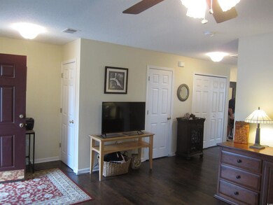 Interior space featuring ceiling fan and dark hard