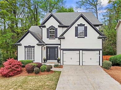 View of front of home with a shingled roof, drivew