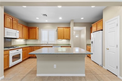 Kitchen with visible vents, a center island, light
