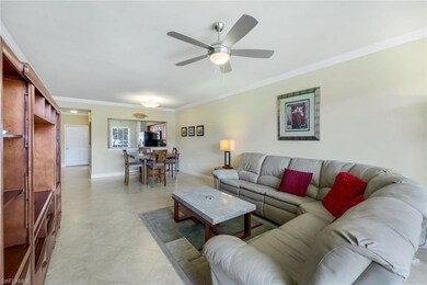 Living room with ceiling fan, ornamental molding, 
