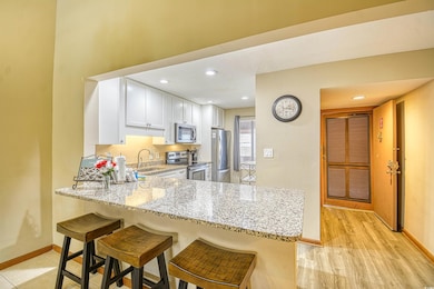 Kitchen with light stone counters, appliances with