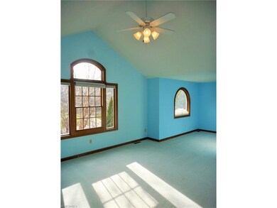 Second floor bedroom with vaulted ceilings and gre