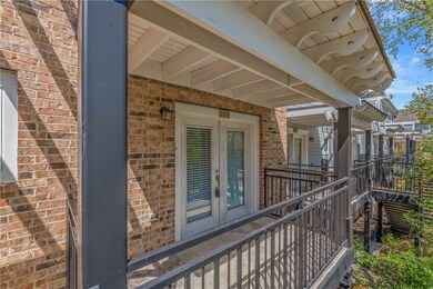 View of exterior entry with brick siding and frenc