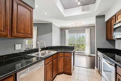 Kitchen with stainless steel appliances, light ti
