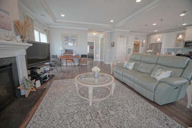 Living area featuring ornamental molding, a high e
