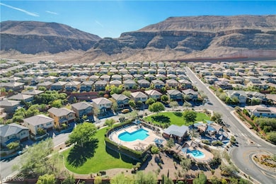 Aerial view of property's location with a mountain backdrop and nearby suburban area
