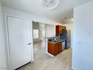 Kitchen featuring a sink, dishwasher, ceiling fan,