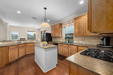 As you enter the kitchen, you will notice the upgraded Silestone (quartz) countertops, gas cooktop and updated lighting and sink fixtures. The center island with power outlet and USB capability is the perfect spot for prepping meals or chatting with dinner guests. The breakfast bar overlooks the breakfast room and living room.