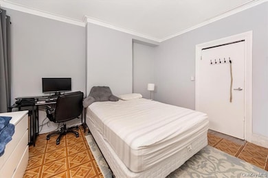 Bedroom with crown molding and an office area