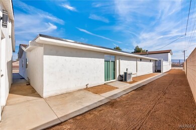 Rear view of house with central AC and a patio are