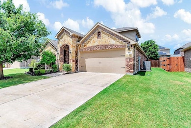 View of front of home featuring stone siding, an attached garage, brick siding, concrete driveway, and a gate