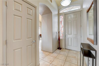 Entrance foyer with light tile patterned flooring