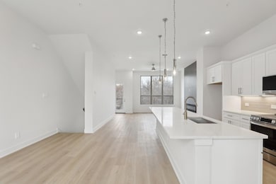 Kitchen with electric range, open floor plan, a ki