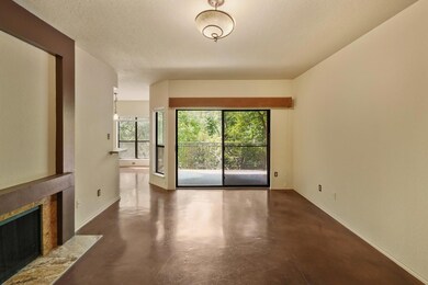 Unfurnished living room featuring baseboards, con