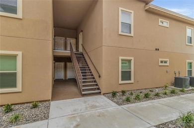 View of property featuring stairs and central AC unit