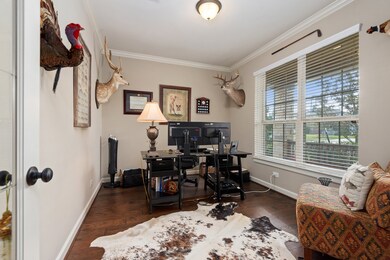 The study has double glass doors and plenty of natural lighting as well as crown moldings.
