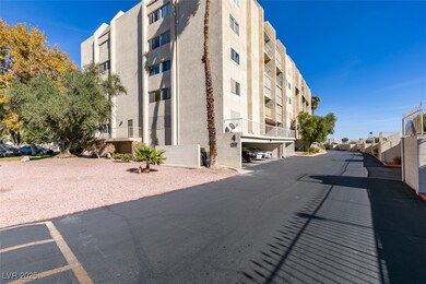 View of property featuring covered parking