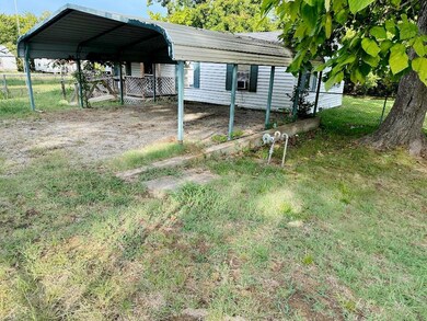 View of yard featuring a carport and cooling unit