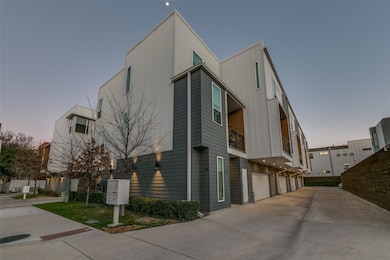 View of side of home featuring driveway and a priv