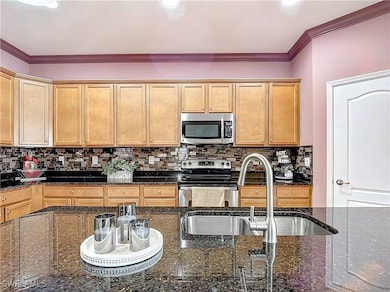 Kitchen with ornamental molding, decorative backsp
