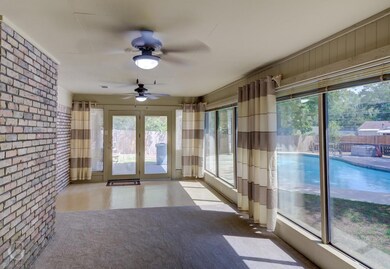 Unfurnished sunroom featuring french doors, brick 