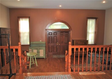 Enter the home through double wood doors with 1/2 