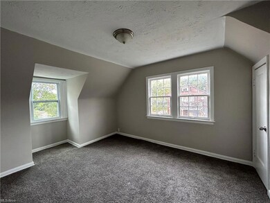 Additional living space with a textured ceiling, d