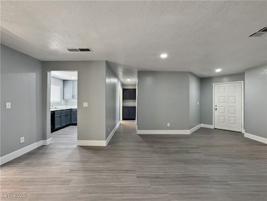 Unfurnished living room with a textured ceiling, d