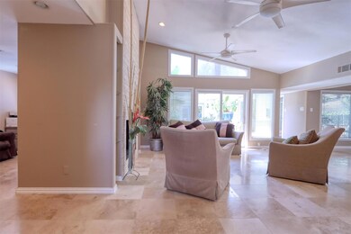 Living room featuring high vaulted ceiling and cei