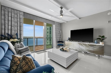 Living room with ceiling fan and tile patterned fl