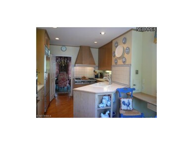 View of kitchen featuring large cooktop, double ov