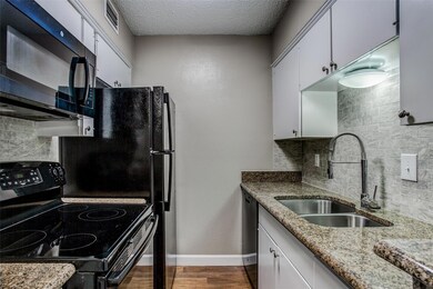 Kitchen with sink, black appliances, hardwood / wo