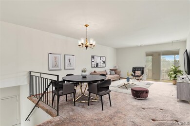 Dining area with carpet flooring and an inviting chandelier